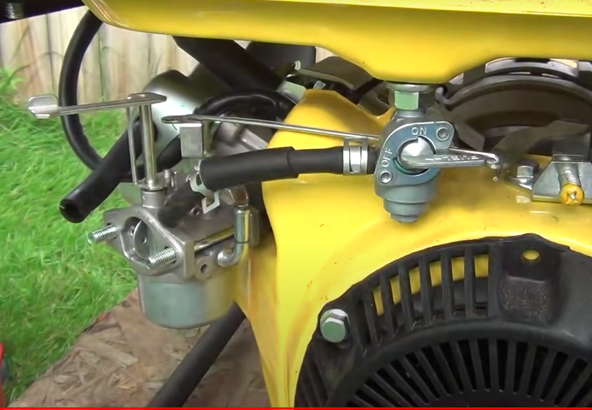 Close up view of the choke and fuel valve on a portable generator.