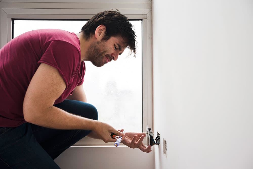 Man testing an electrical plug