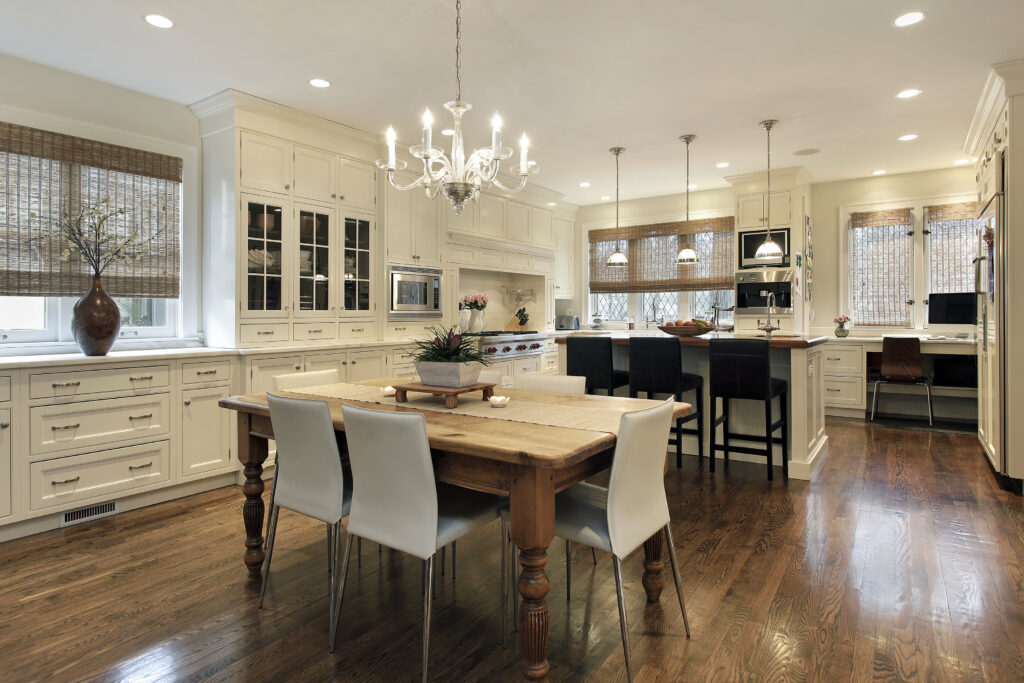 A kitchen with white cabinets and a large island